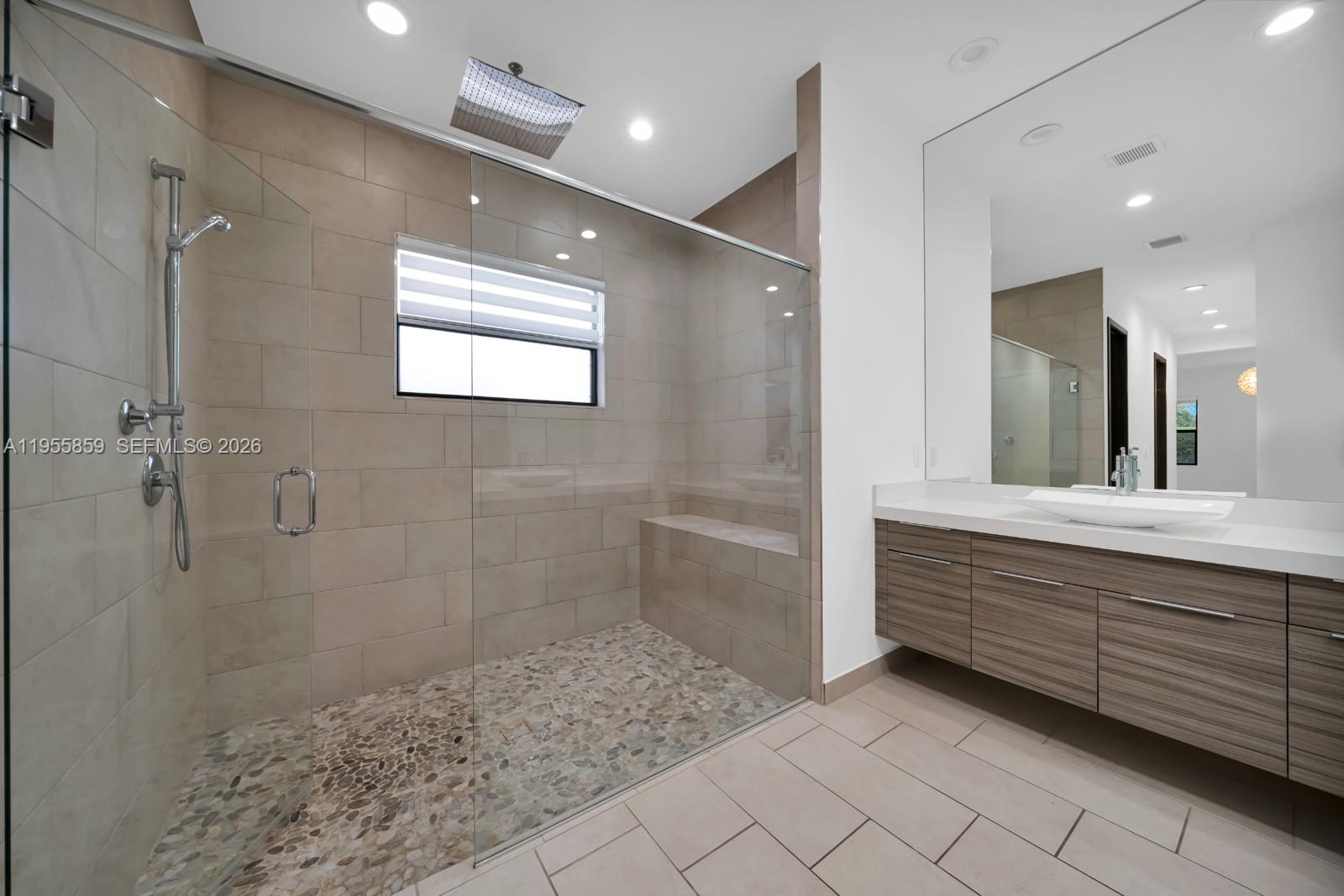15877 Southwest 136 Way Miami, FL 33196 - Photo 15 of 18 a bathroom with a sink a toilet a large mirror and shower