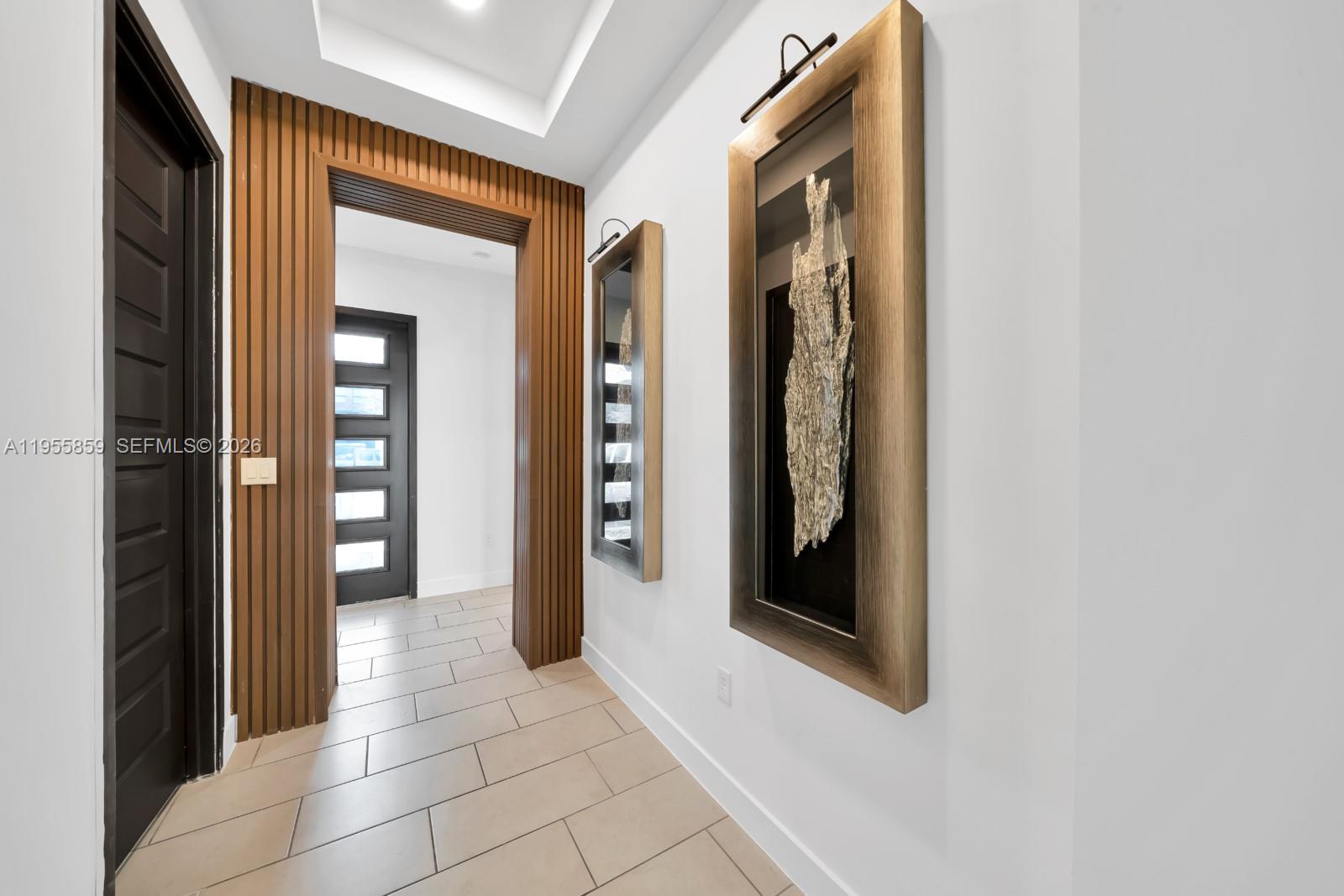 15877 Southwest 136 Way Miami, FL 33196 - Photo 3 of 18 a view of a hallway with wooden floor and a bathroom