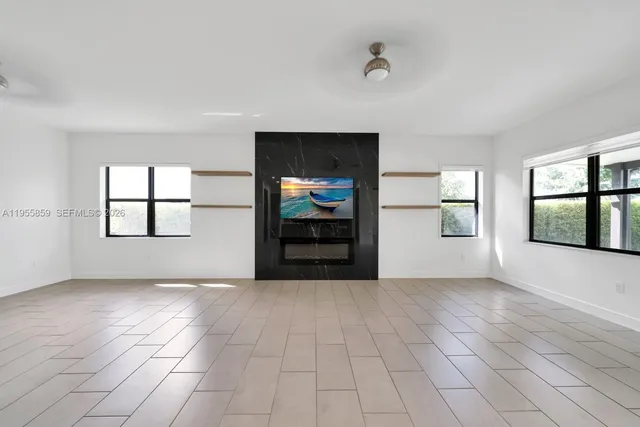 an empty room with windows and closet