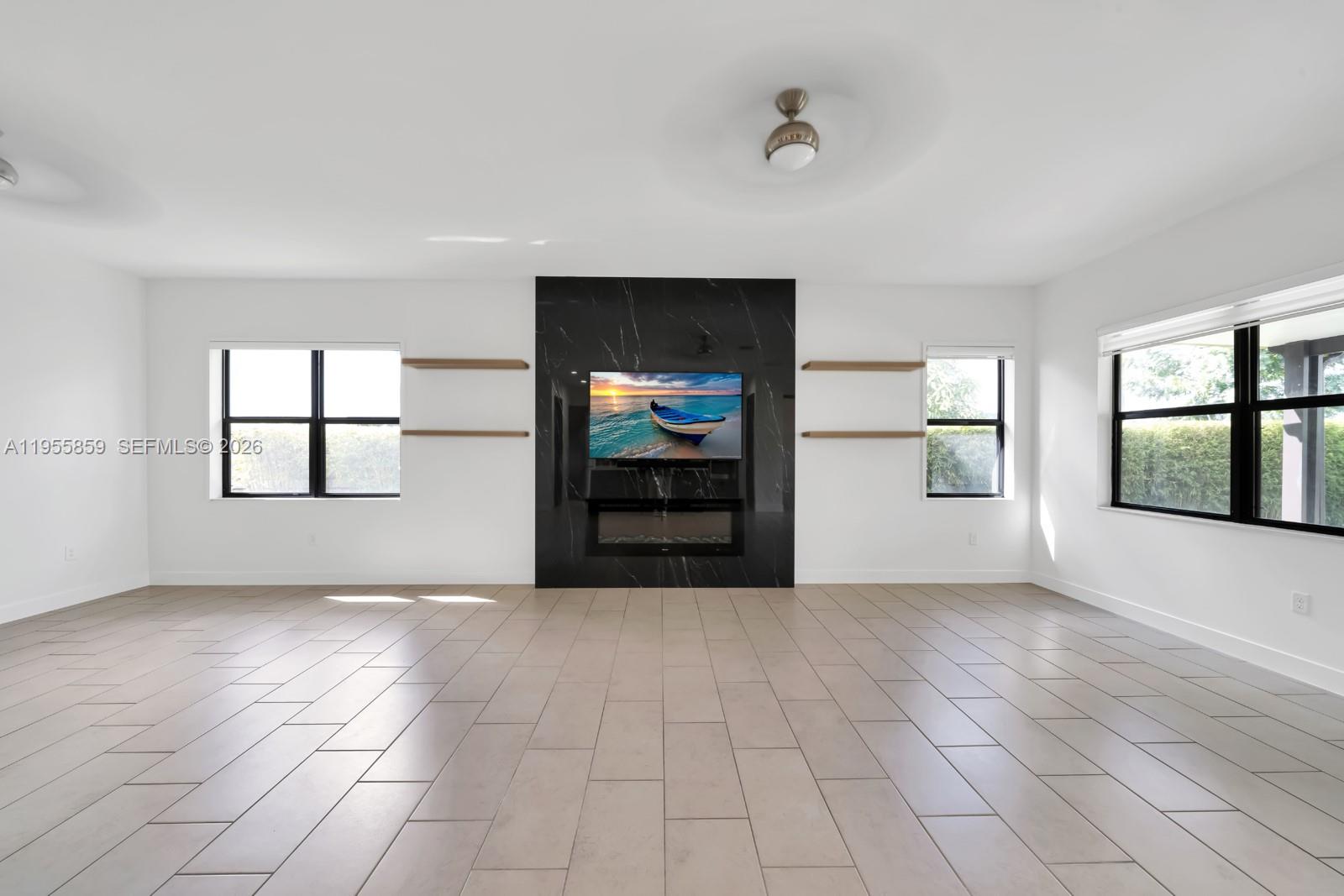 15877 Southwest 136 Way Miami, FL 33196 - Photo 7 of 18 an empty room with windows and closet