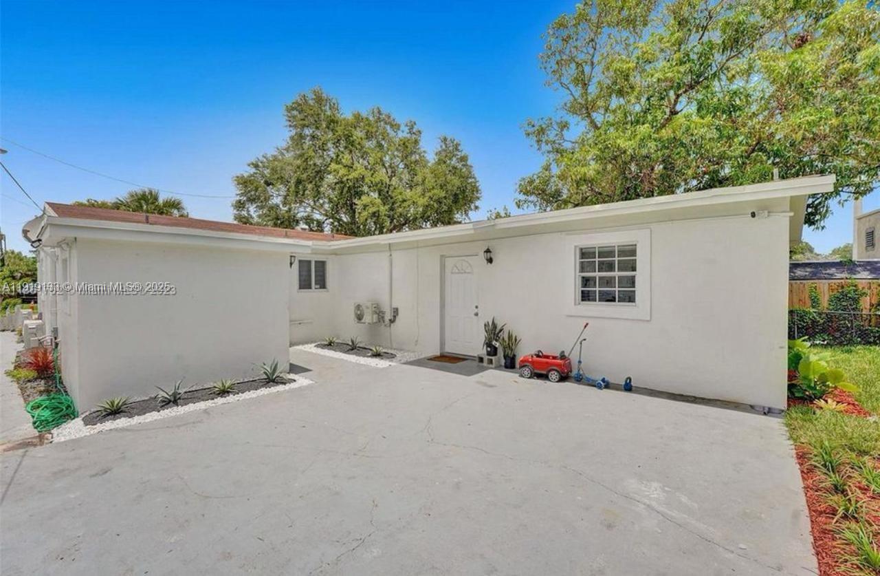 685 Southwest 7th Terrace, Unit 3 Dania Beach, FL 33004 - Photo 1 of 9 a view of the house with a outdoor space