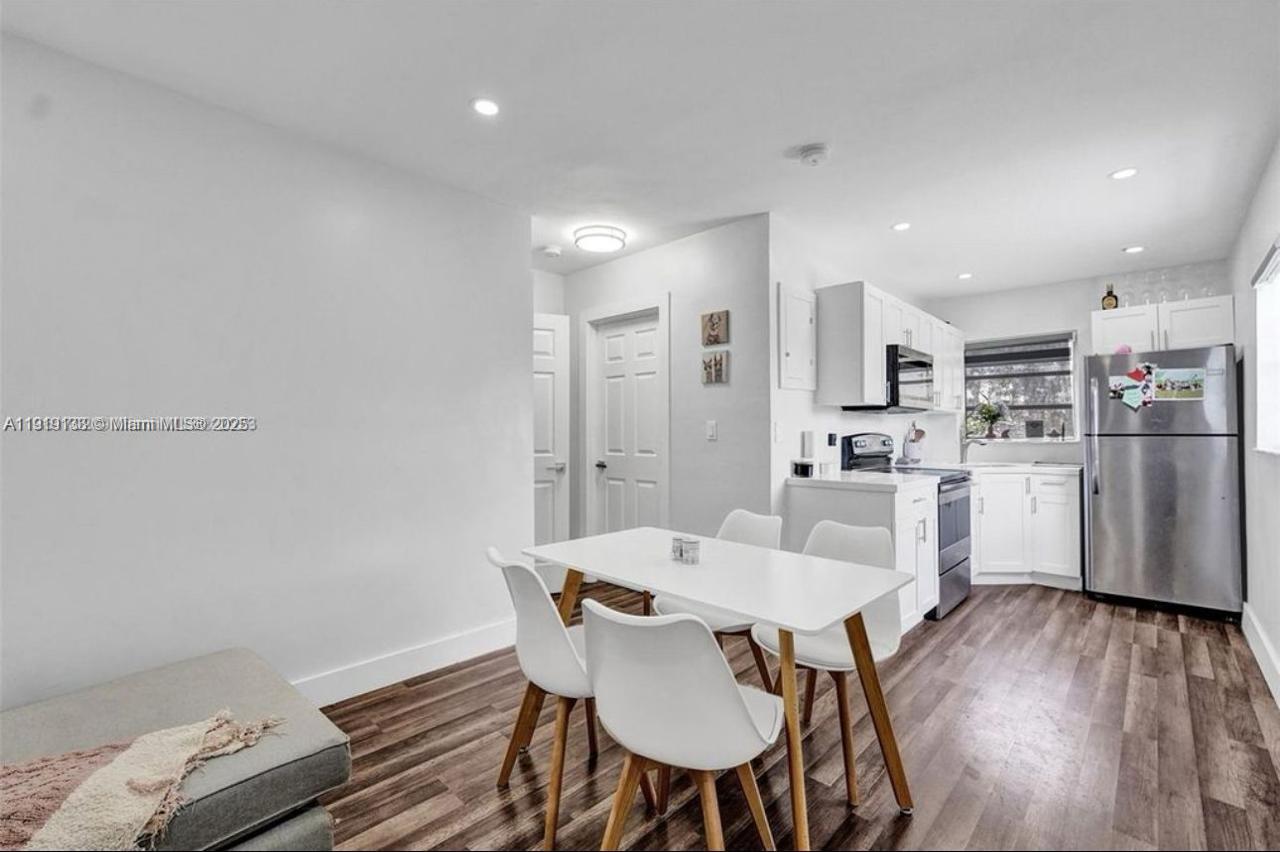 685 Southwest 7th Terrace, Unit 3 Dania Beach, FL 33004 - Photo 2 of 9 a view of a dining room with furniture and wooden floor