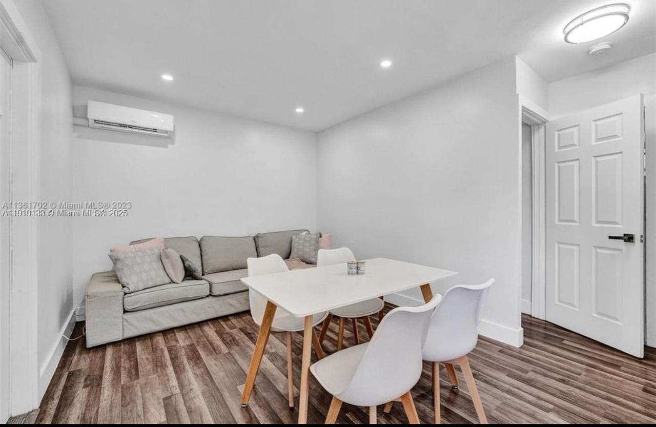 685 Southwest 7th Terrace, Unit 3 Dania Beach, FL 33004 - Photo 3 of 9 a living room with furniture and a wooden floor