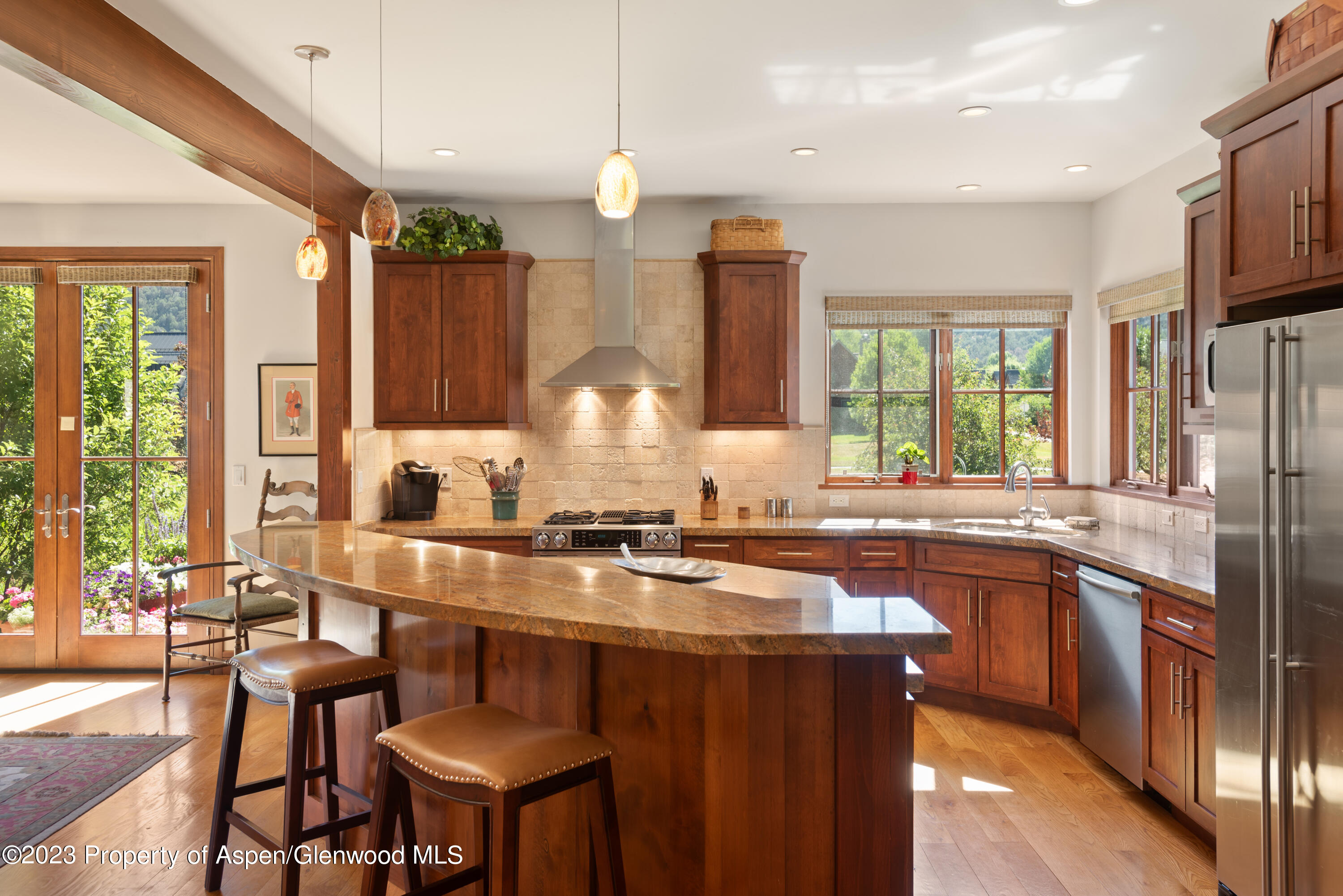 346 Sopris Circle Basalt, CO 81621 - Photo 11 of 25 a kitchen with stainless steel appliances granite countertop a stove a sink dishwasher a refrigerator and couches with wooden floor
