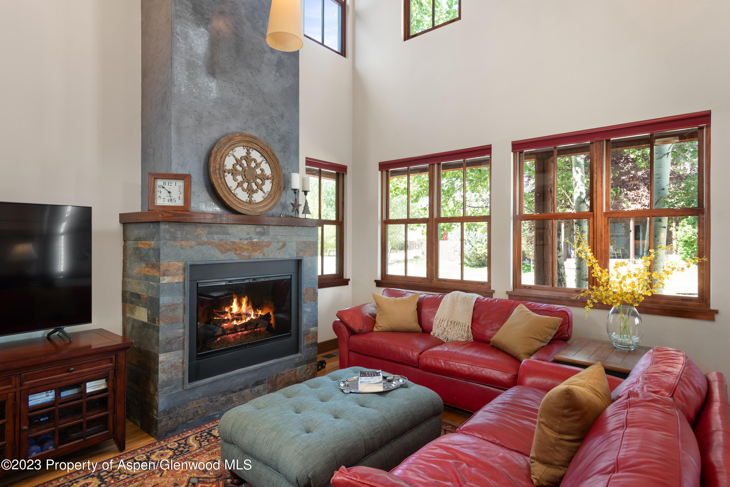 346 Sopris Circle Basalt, CO 81621 - Photo 13 of 25 a living room with furniture a flat screen tv and a fireplace