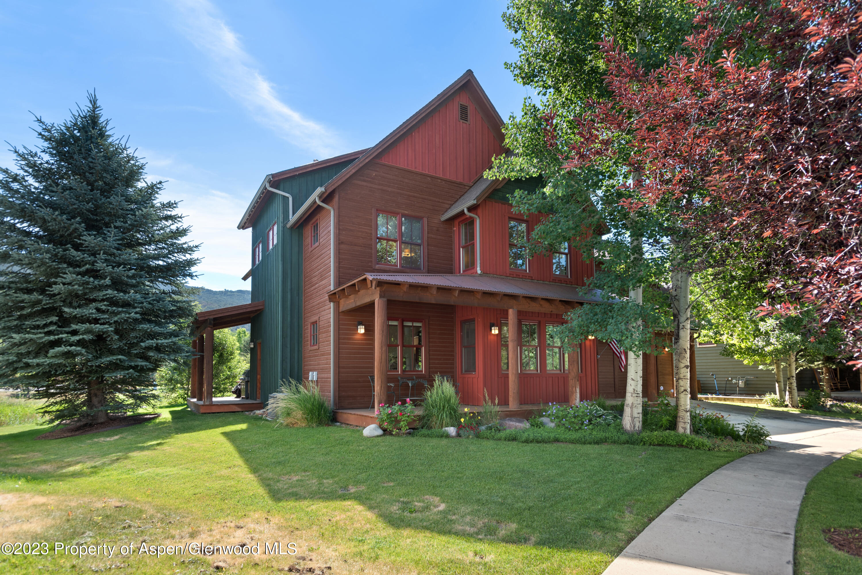 346 Sopris Circle Basalt, CO 81621 - Photo 2 of 25 a view of a brick house with a big yard and large trees
