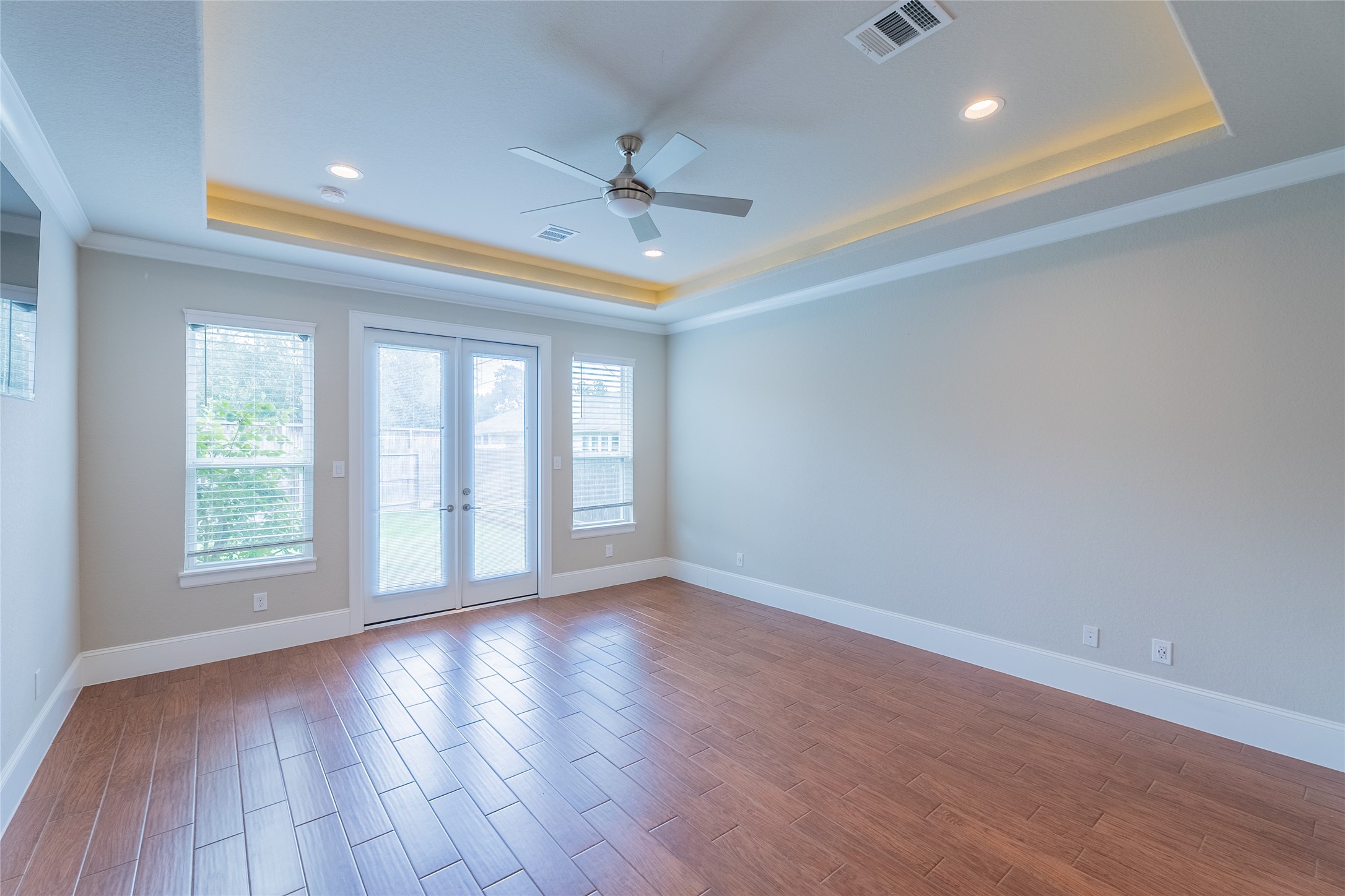 25718 Muirfield Bend Court Spring, TX 77389 - Photo 18 of 50 an empty room with wooden floor and windows