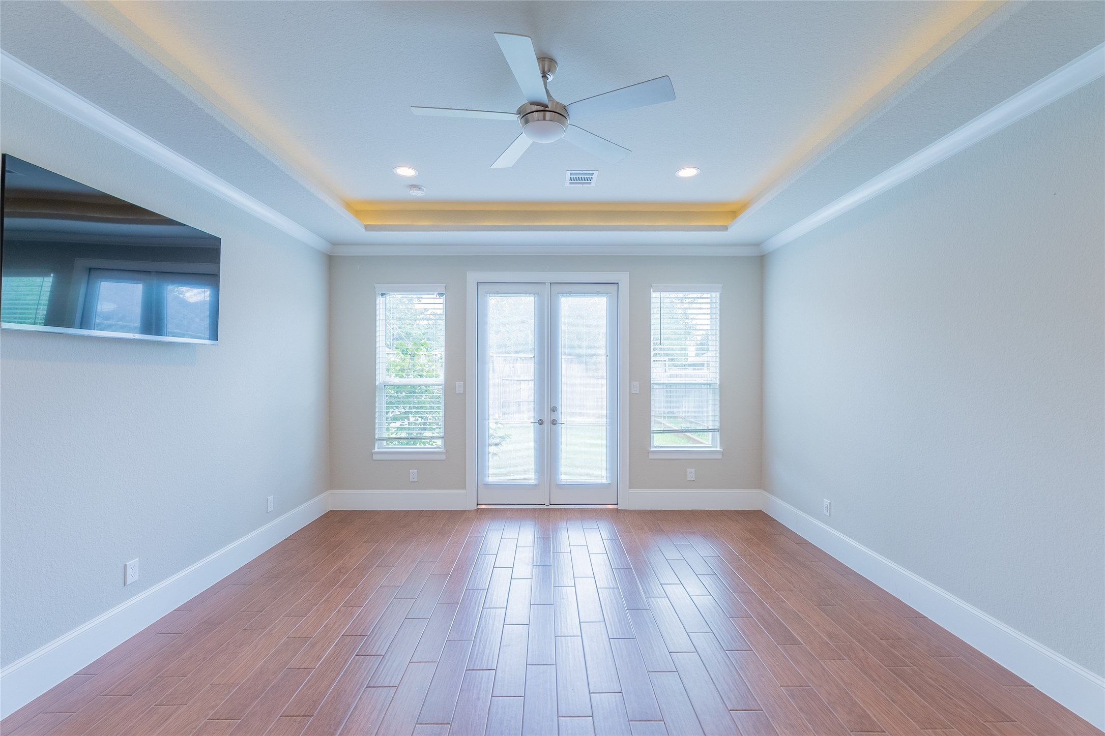 25718 Muirfield Bend Court Spring, TX 77389 - Photo 19 of 50 a view of an empty room with wooden floor and a window