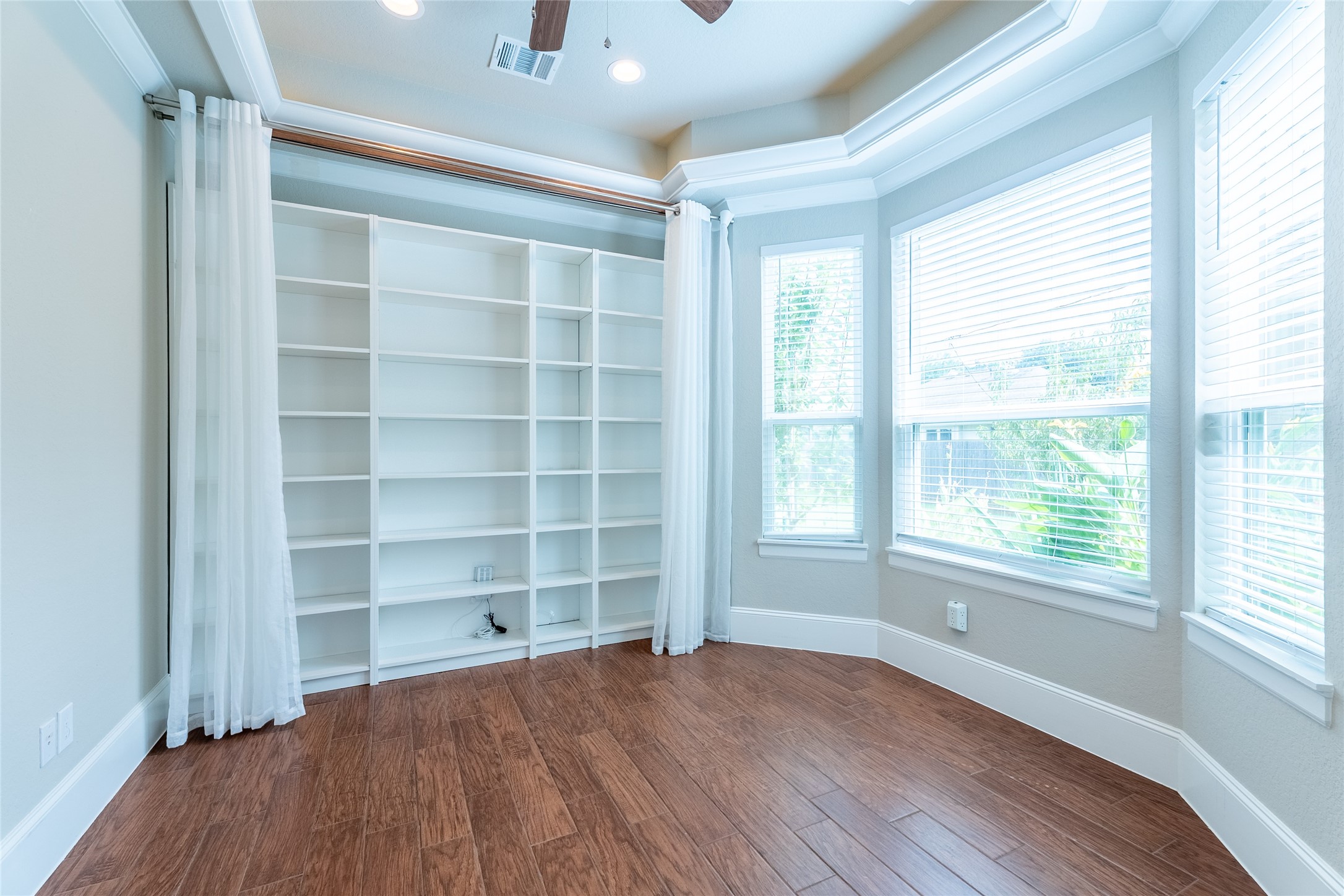 25718 Muirfield Bend Court Spring, TX 77389 - Photo 8 of 50 a view of an empty room with a window and wooden floor