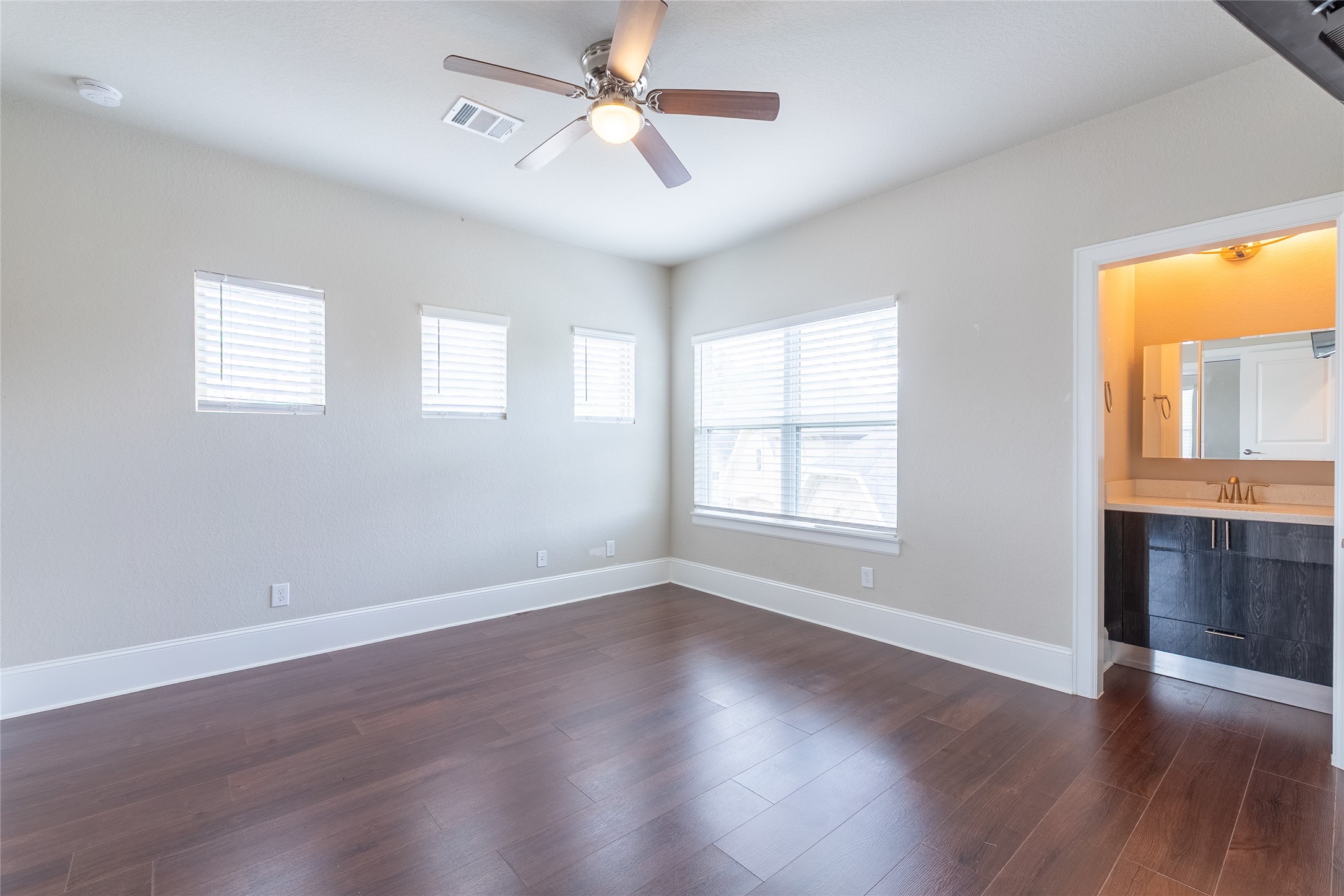 25718 Muirfield Bend Court Spring, TX 77389 - Photo 9 of 50 a view of an empty room with a window and wooden floor