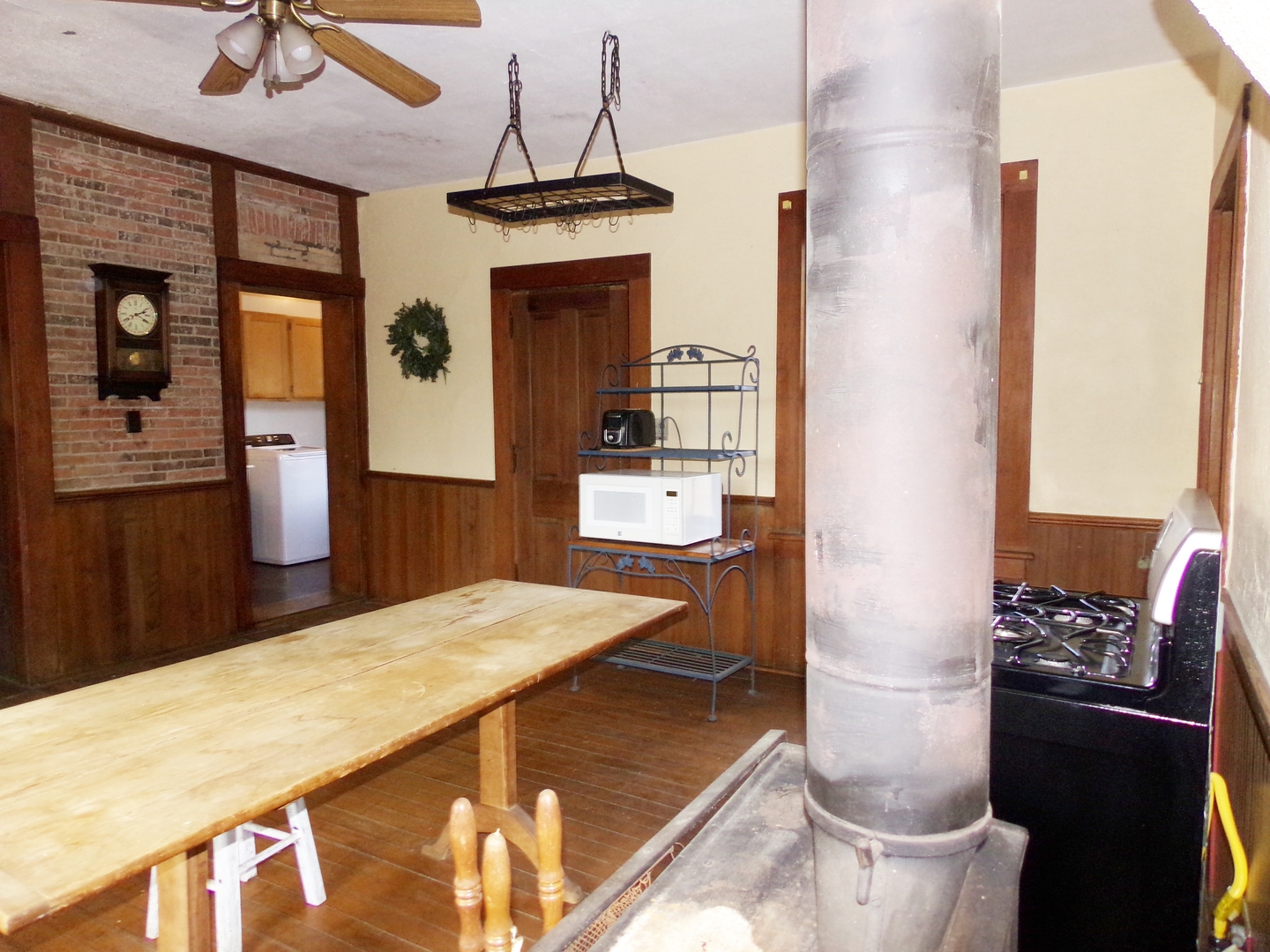 N955 Pouley Road Elburn, IL 60119 - Photo 7 of 23 a dining room with stainless steel appliances kitchen island granite countertop furniture and a fireplace