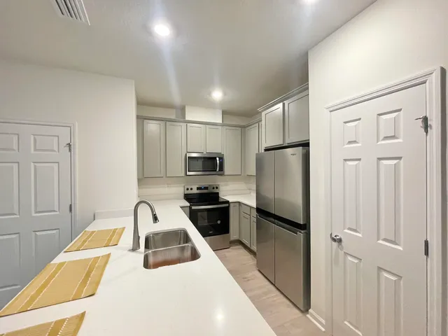 a bathroom with a bathtub shower sink vanity and toilet