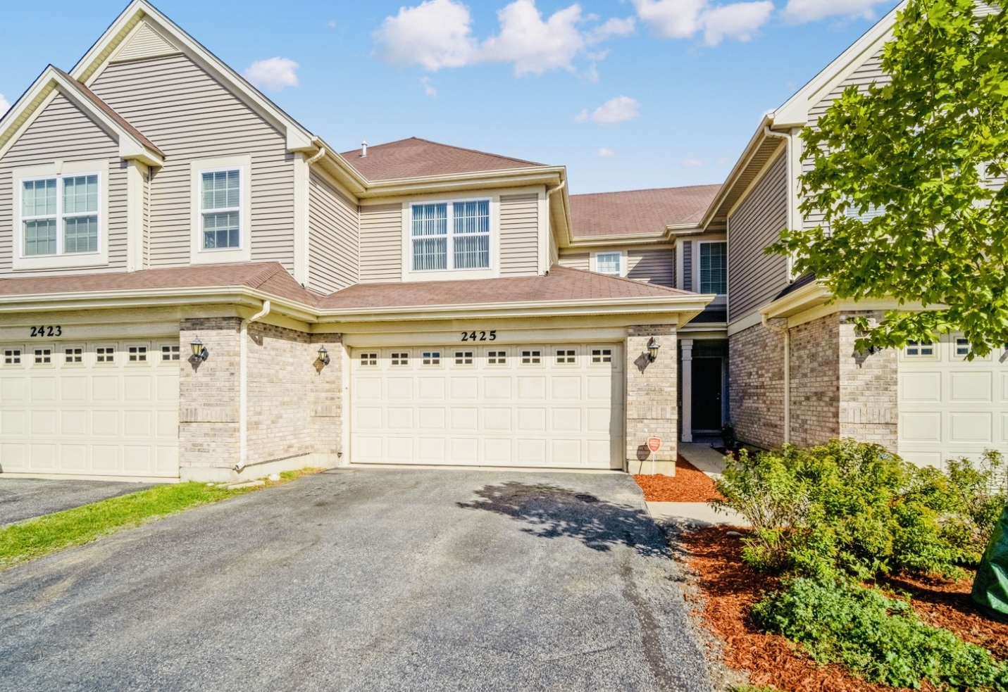 a front view of a house with a yard and garage