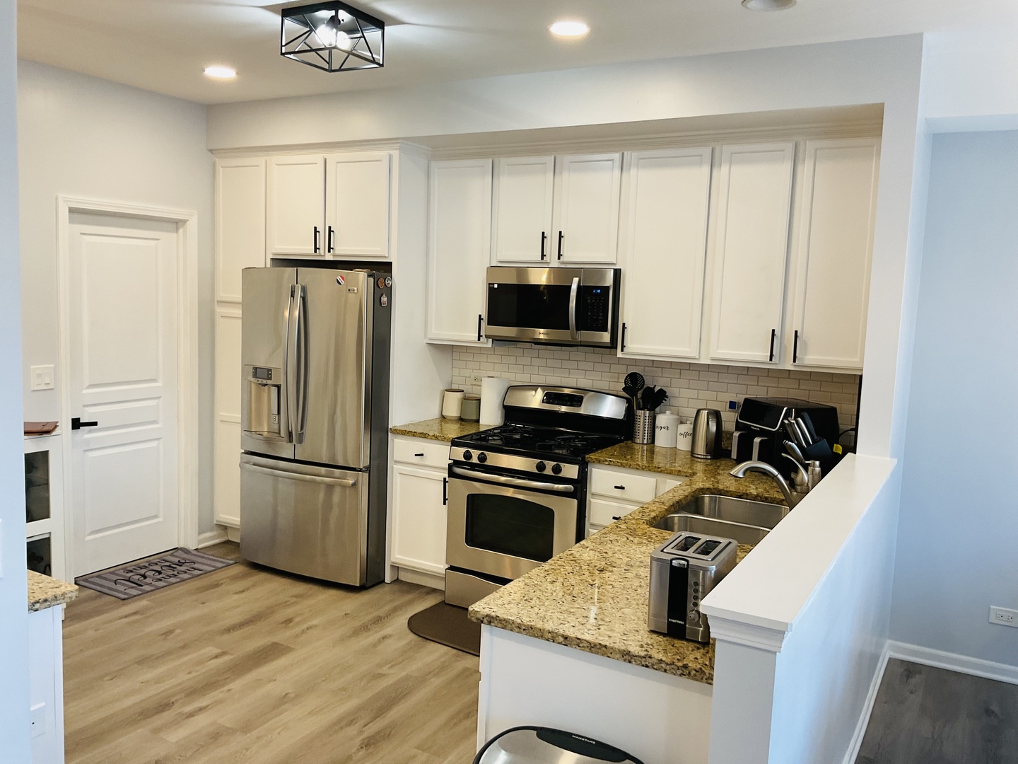 2425 Birch Street Des Plaines, IL 60018 - Photo 9 of 40 a kitchen with a refrigerator a stove top oven a sink and dishwasher