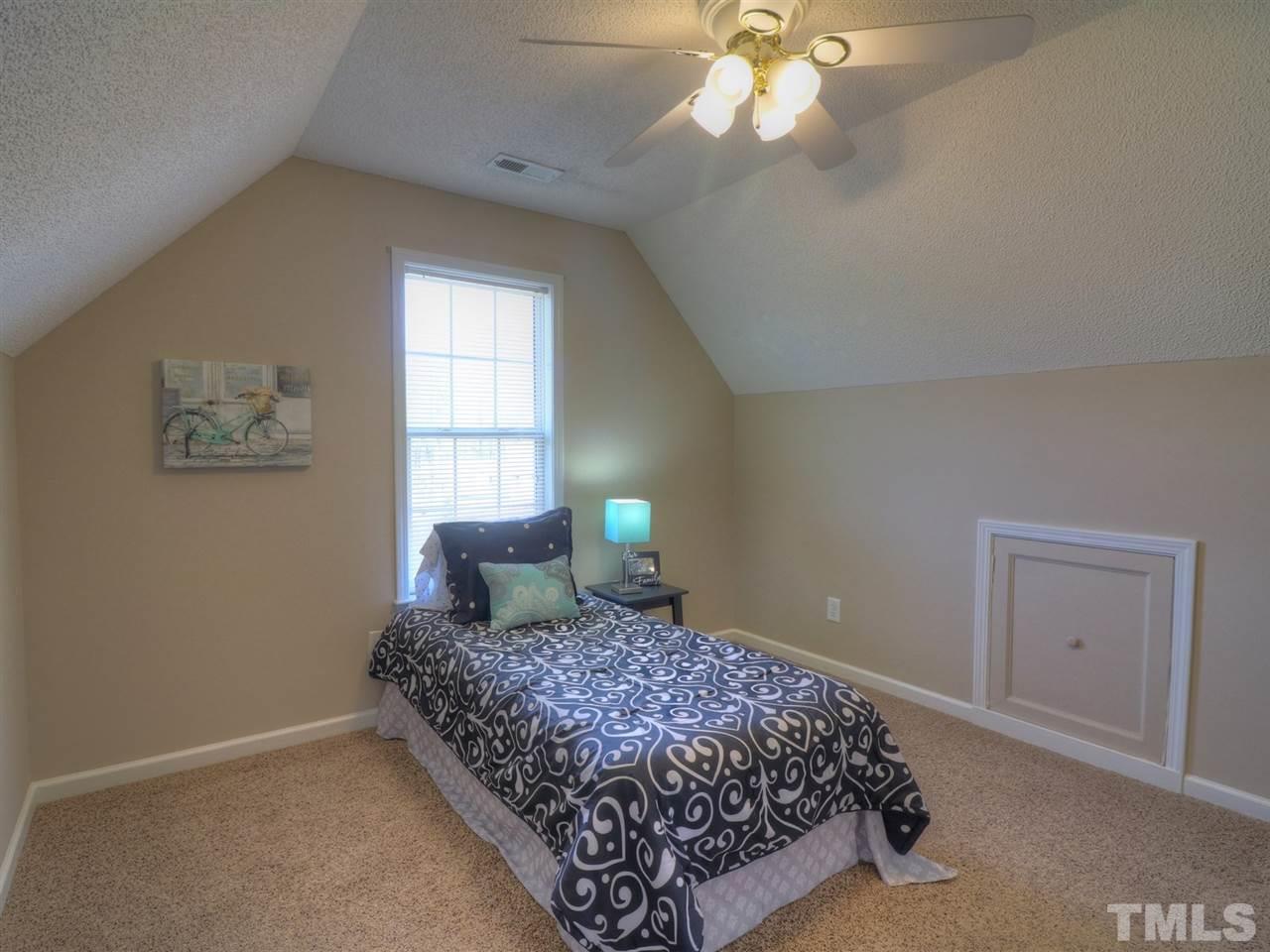 8505 Rockcliff Road Raleigh, NC 27603 - Photo 14 of 25 a bedroom with a bed and window