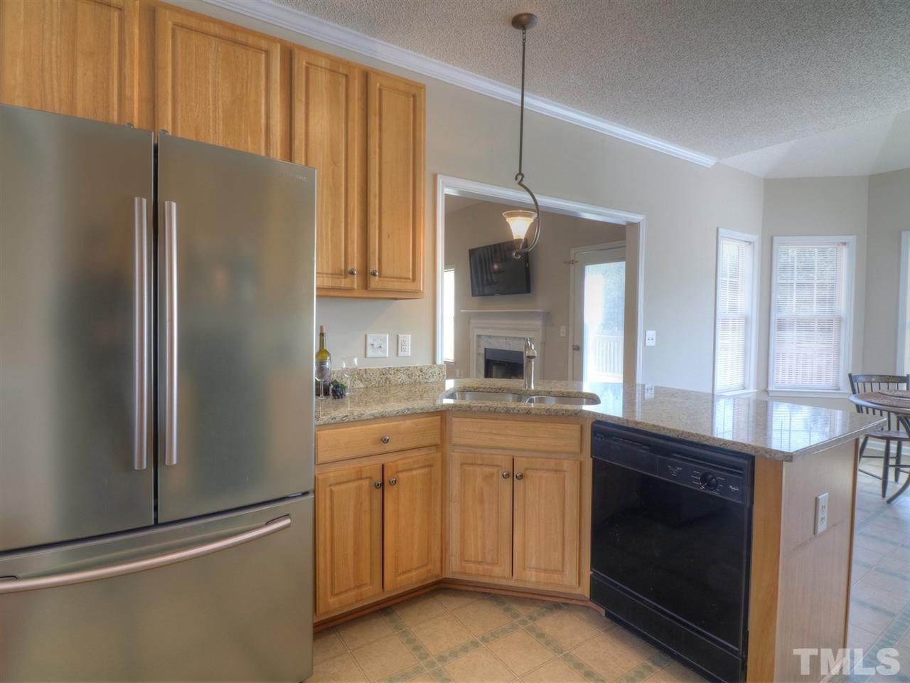 8505 Rockcliff Road Raleigh, NC 27603 - Photo 3 of 25 a kitchen with stainless steel appliances a refrigerator sink and cabinets