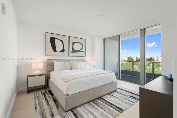 a bedroom with a large bed and a large window