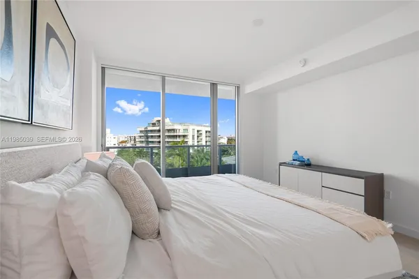 a bedroom with a bed and mirror