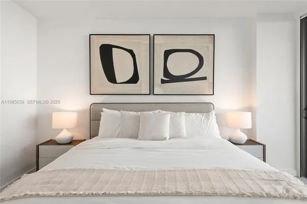 a bedroom with a bed and a lamp