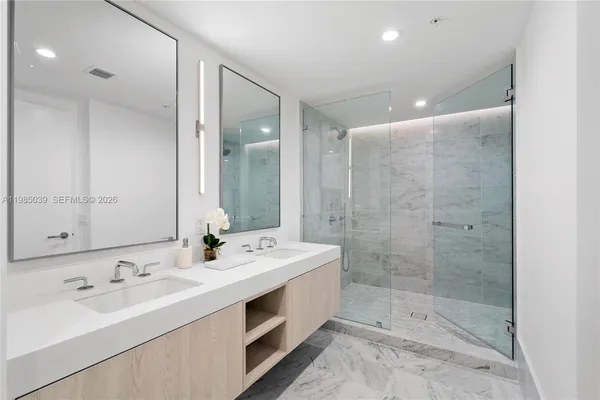 a bathroom with a sink double vanity and a toilet