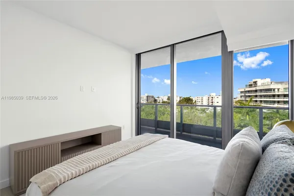 a bedroom with a bed and a night stand