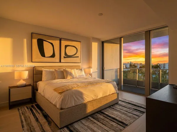 a bedroom with a bed and lamp next to a window