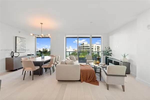a living room with furniture and a floor to ceiling window