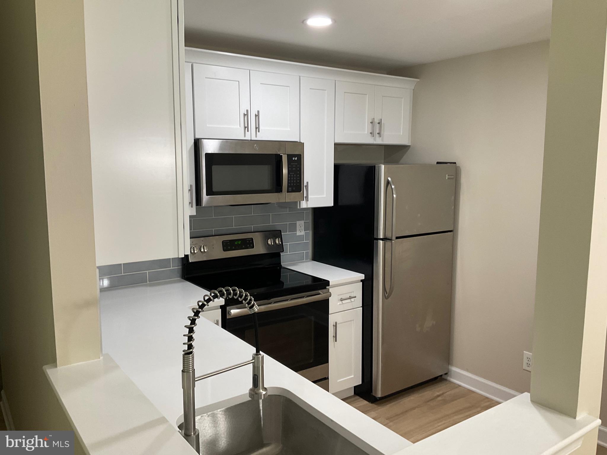 303 Quail Road Marlton, NJ 08053 - Photo 7 of 26 a kitchen with a refrigerator stove and microwave