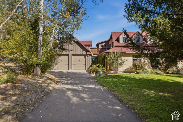 725 Canyon Road Smithfield, UT 84335 - Photo 4 of 100 Asphalt driveway leading to a two-car garage with carriage-style doors