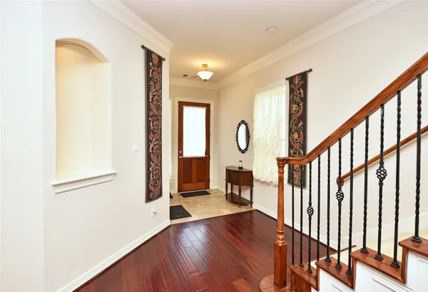 a view of entryway with wooden floor and door