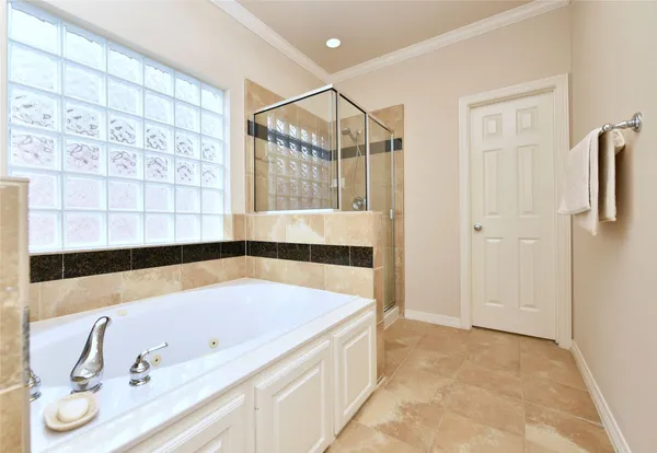 a bathroom with a tub and a shower