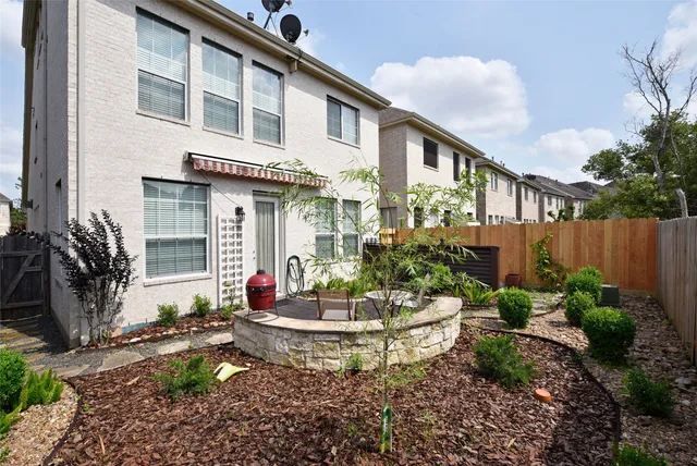a building outdoor space with patio furniture and potted plants