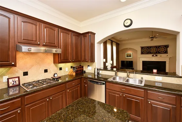 a kitchen with wooden cabinets and a stove top oven
