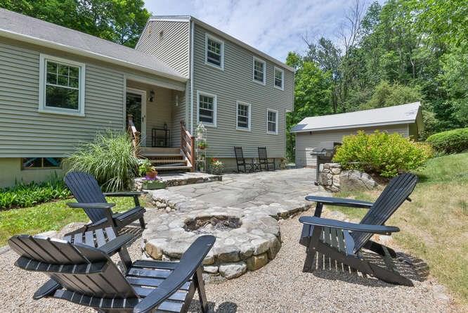 a view of backyard of house with seating space