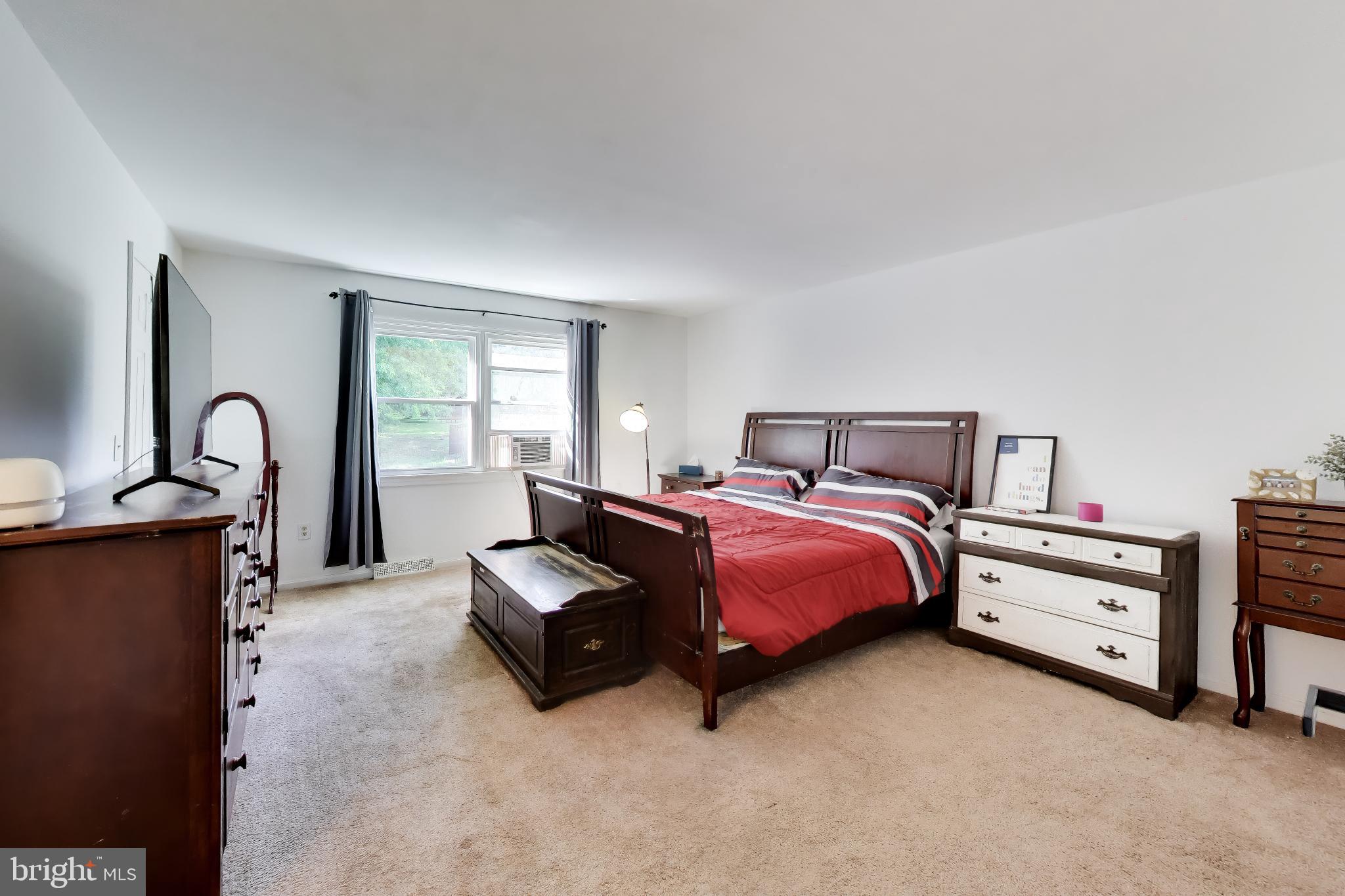 3240 Juniper Lane Huntingtown, MD 20639 - Photo 10 of 48 a spacious bedroom with a bed and a dresser next to a window