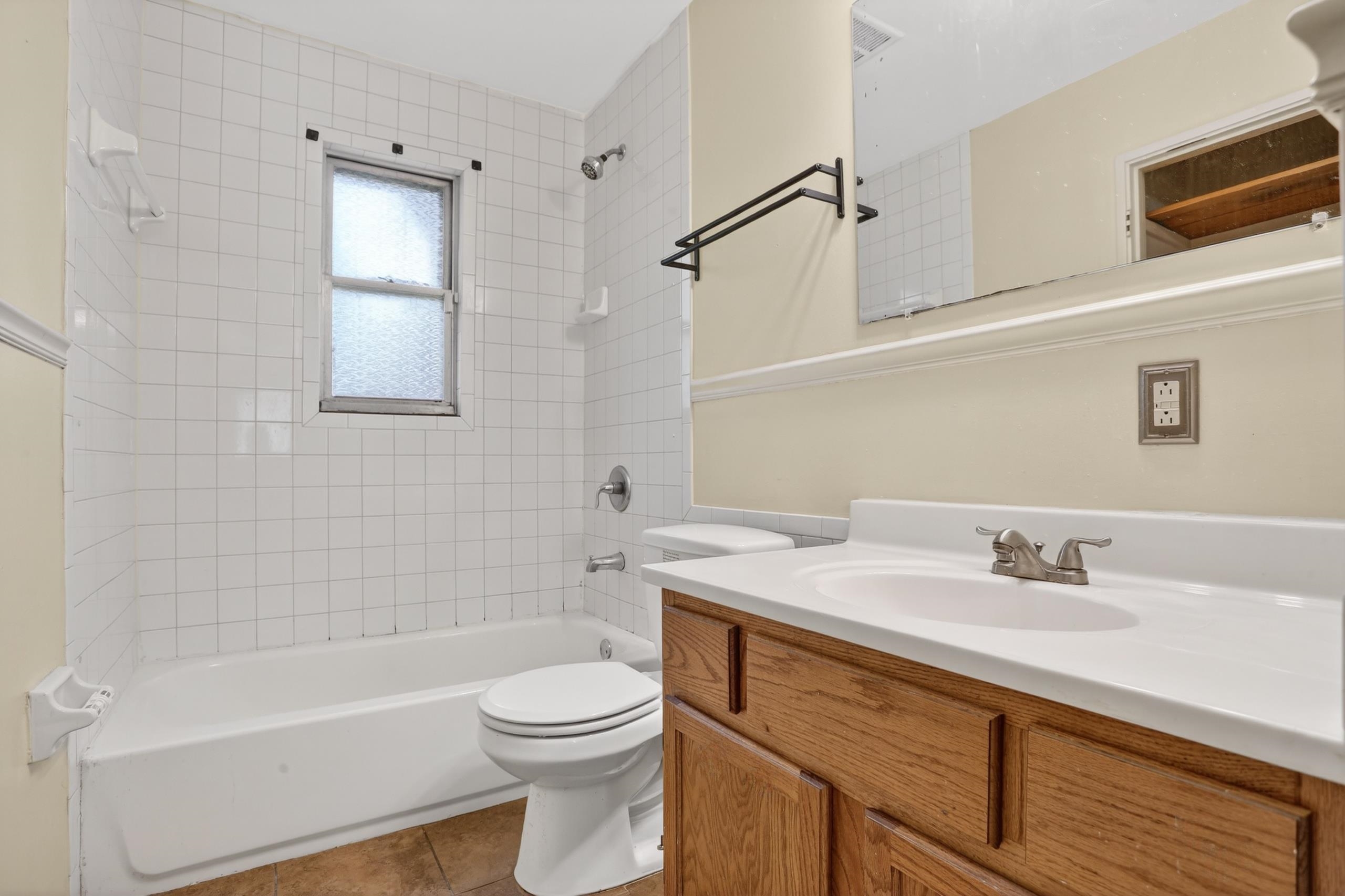 4924 Verne Road Memphis, TN 38117 - Photo 10 of 19 Full bathroom with vanity, shower combination, and light tile patterned flooring