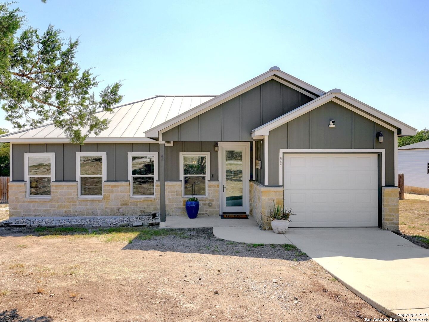 6766 Spring Branch Road Spring Branch, TX 78070 - Photo 1 of 63 a front view of a house with a yard and garage