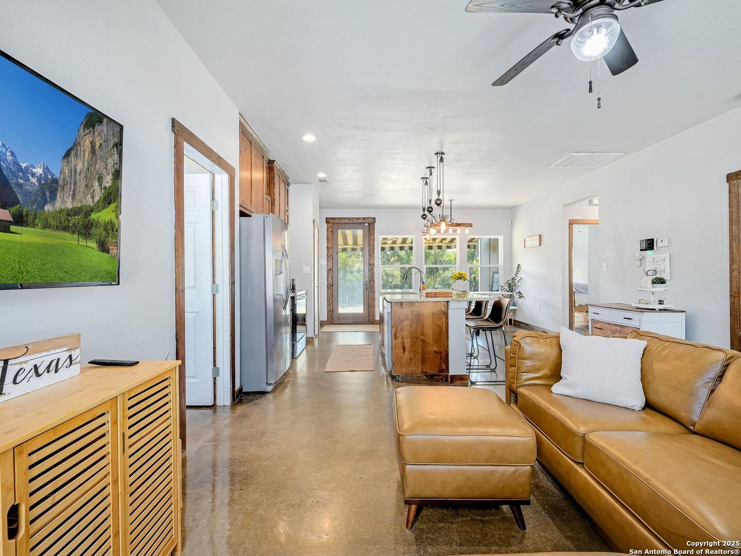 6766 Spring Branch Road Spring Branch, TX 78070 - Photo 15 of 63 a living room with furniture and a chandelier