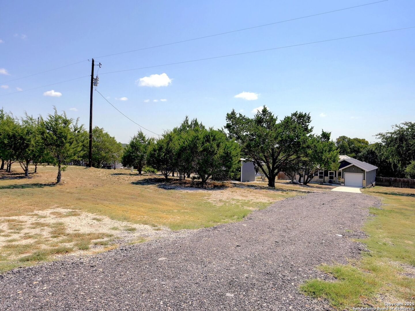 6766 Spring Branch Road Spring Branch, TX 78070 - Photo 2 of 63 a view of a swimming pool with an outdoor space and seating area
