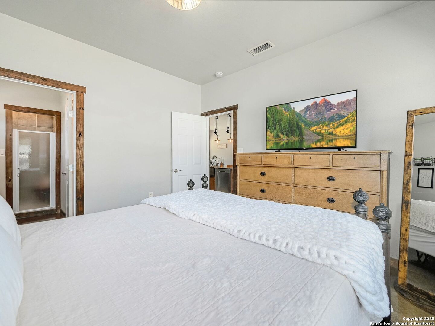 6766 Spring Branch Road Spring Branch, TX 78070 - Photo 23 of 63 a bedroom with a bed and a flat screen tv