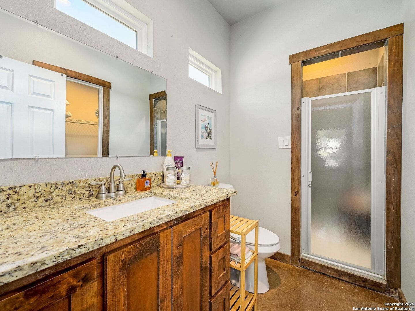 6766 Spring Branch Road Spring Branch, TX 78070 - Photo 24 of 63 a bathroom with a granite countertop sink and a mirror