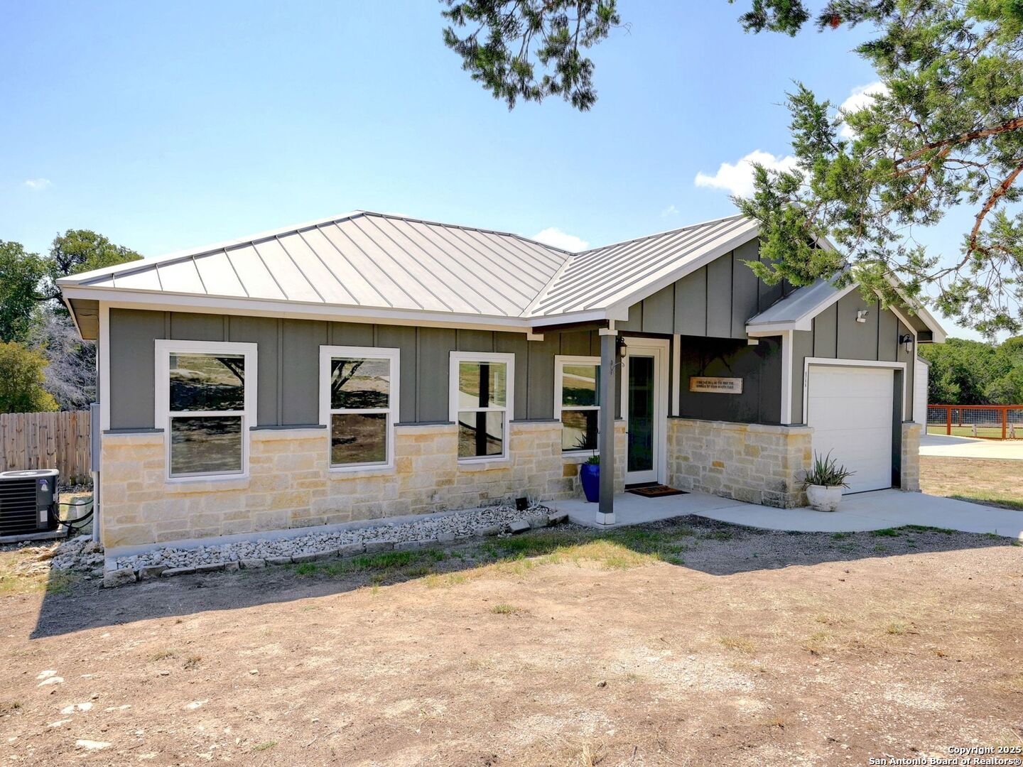 6766 Spring Branch Road Spring Branch, TX 78070 - Photo 3 of 63 a front view of a house with a yard and potted plants