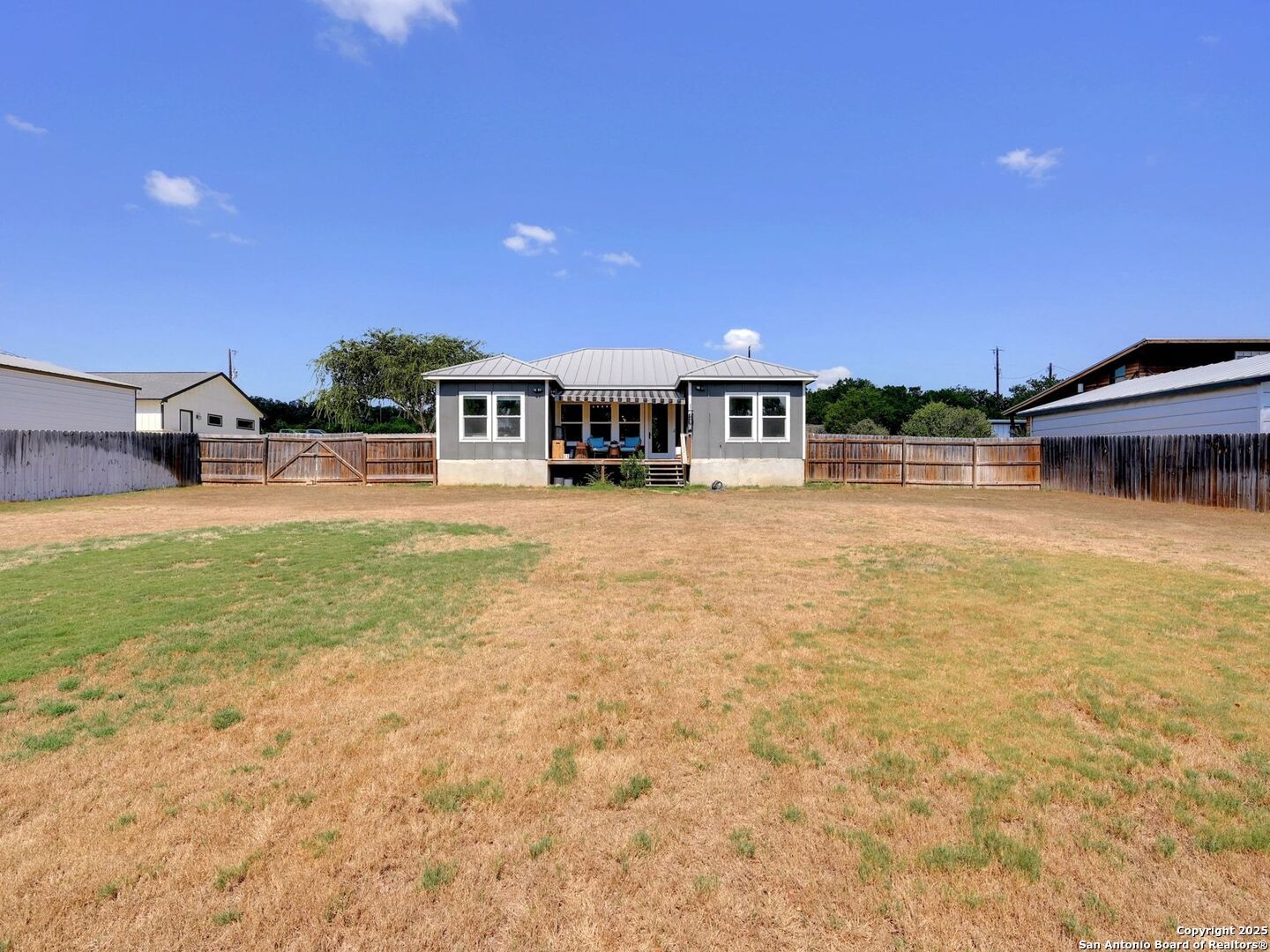6766 Spring Branch Road Spring Branch, TX 78070 - Photo 33 of 63 a view of a house with a yard and sitting area