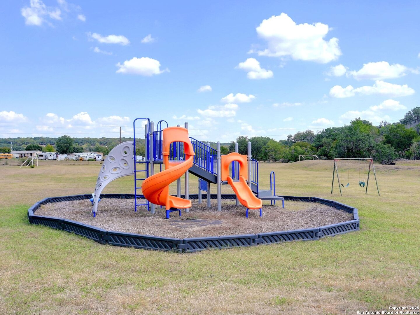 6766 Spring Branch Road Spring Branch, TX 78070 - Photo 46 of 63 a view of a swimming pool with a table and chairs