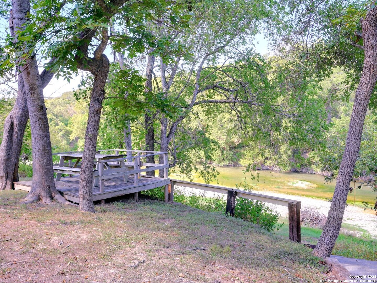6766 Spring Branch Road Spring Branch, TX 78070 - Photo 53 of 63 a view of backyard with large trees and wooden fence