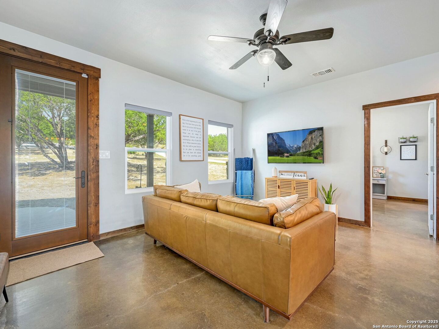 6766 Spring Branch Road Spring Branch, TX 78070 - Photo 6 of 63 a living room with furniture and a flat screen tv