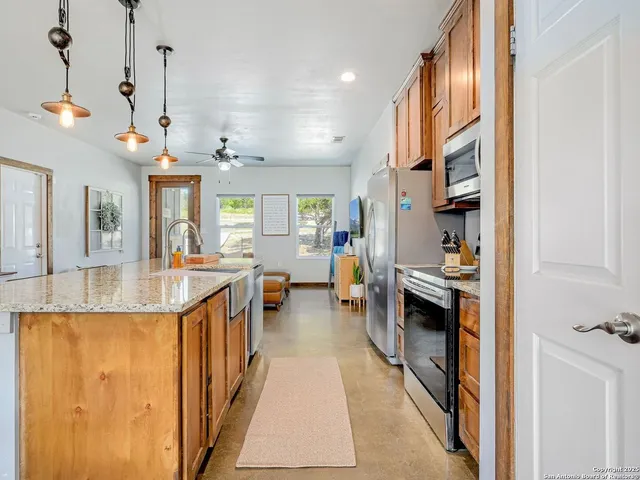 a view of living room with granite countertop furniture and a chandelier