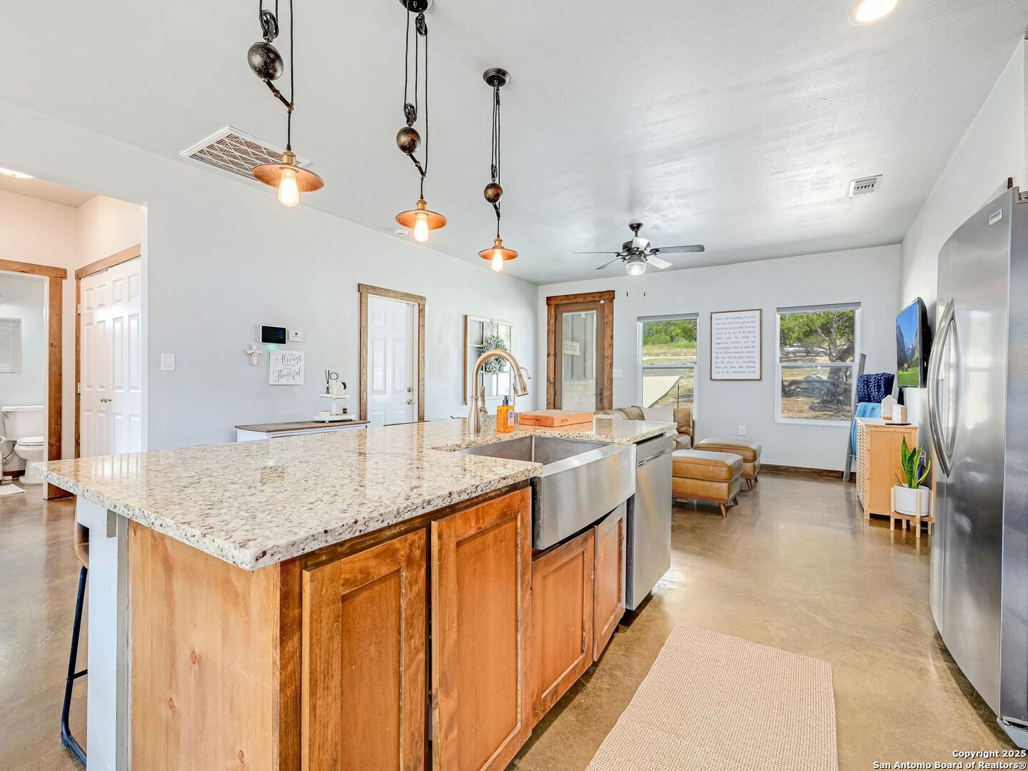 6766 Spring Branch Road Spring Branch, TX 78070 - Photo 10 of 63 a view of living room with granite countertop furniture and a chandelier