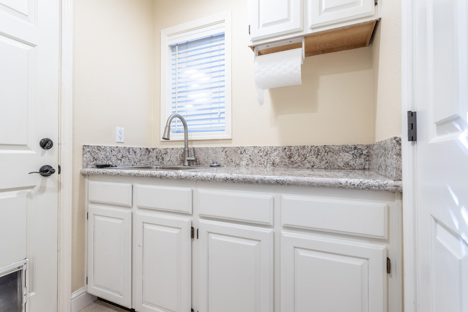 3126 Riesling Path Redding, CA 96001 - Photo 20 of 32 a bathroom with a granite countertop sink and white cabinets