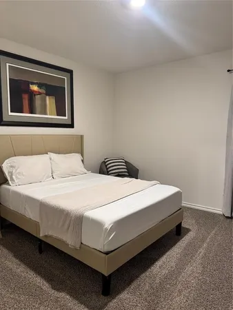 a bedroom with a bed and wall painting